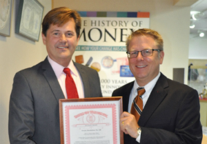 Bieda presents a copy of the resolution to ANA Past President Tom Hallenbeck.